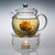 Teaposy dream posy set showing heart of love tea blooming in the daydream glass teapot on the light my fire tea warmer